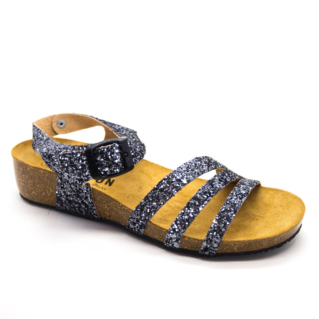Experience the epitome of glamour with our 241007 Pewter Glitter Sandals. The dazzling glitter finish adds sparkle to any ensemble, while the low cork wedge and adjustable ankle fastening ensure both style and comfort. Step into effortless elegance.